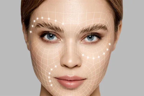 Aesthetic-Fillers-Doctor Close-up of a beautiful face against a gray background, with flowing gridlines illustrated along the cheeks, brow and lips, representing aesthetic filler services from Regenerative Medical Institute in Greenville.