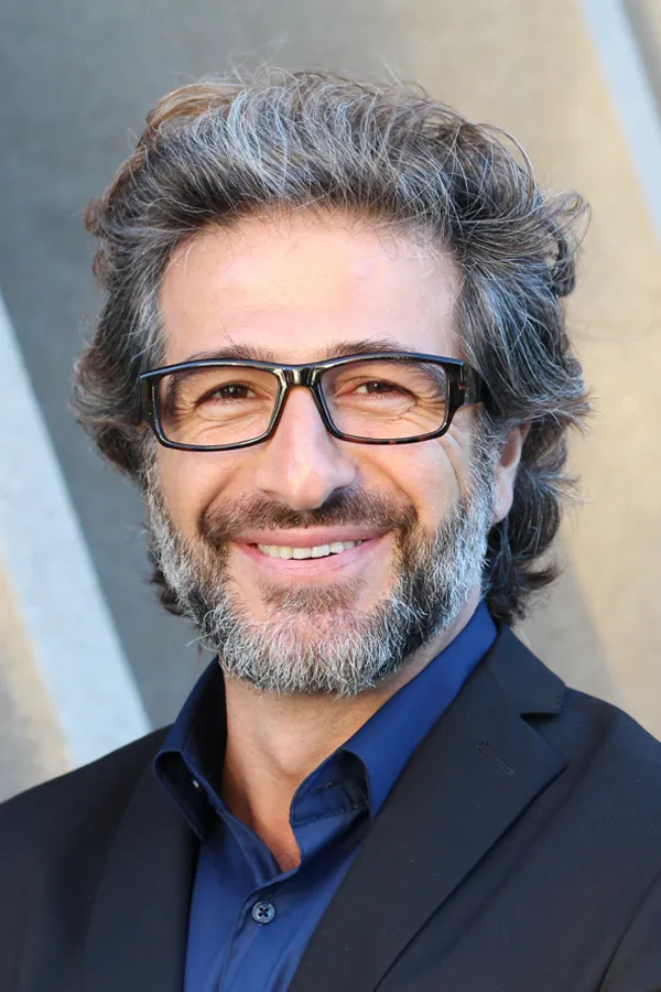 Andropause-and-Low-Testosterone-Treatment A man with glasses, salt and pepper hair and a beard smiling because he received treatment for andropause and low testosterone from Regenerative Medical Institute in Greenville.