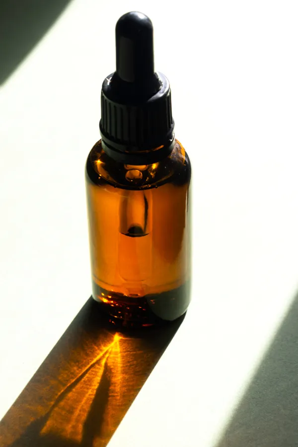 DeriveHairRestoration-Treatment Close up of a brown bottle with a squeeze dropper representing Derive Hair Restoration Treatment in Greenville.