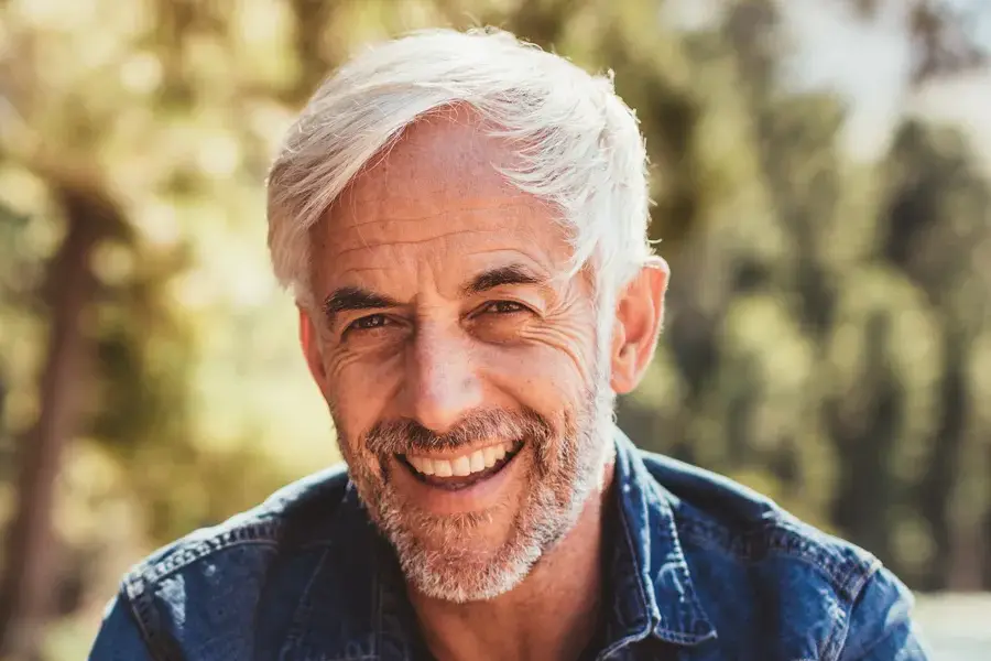 Mens-Health-Clinic A handsome mature man smiling in the forest. Make an appointment with men's health expert Regenerative Medical Institute in Greenville today.