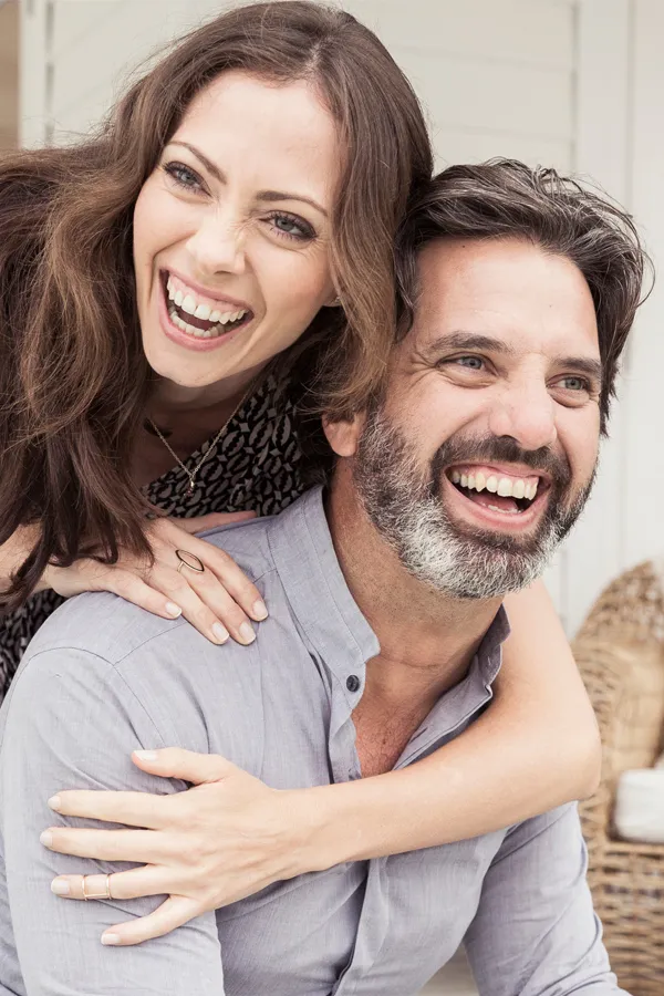 A couple laughing and smiling about receiving anti-aging medicine treatment from Regenerative Medical Institute in Greenville.