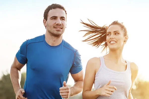 Weight-Loss-Resistance-Doctor A couple happily jogging in the sunlight after receiving effective weight loss resistance care from Regenerative Medical Institute in Greenville.